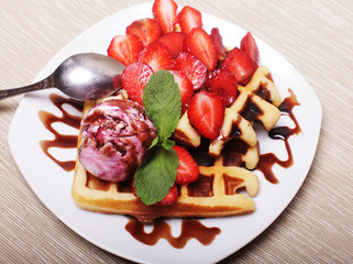 delicious waffles with strawberry and ice cream
