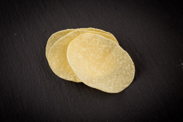 Potato chips on a black background