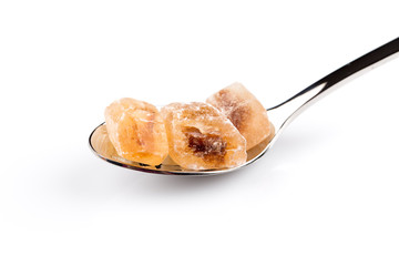 brown caramelized sugar in a wooden spoon