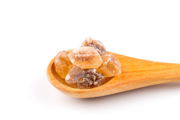 brown caramelized sugar in a wooden spoon