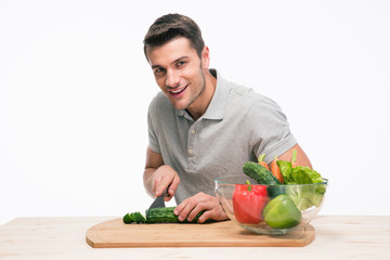 Fototapeta premium Happy man cutting vegetables