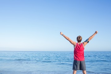 Handsome man raising arms