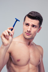 Young man holding razor