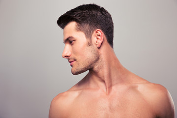 Naklejka premium Young man with naked torso looking away
