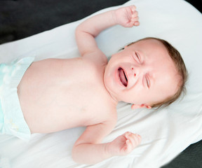 Nice newborn in diaper crying