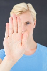 Stern woman gesturing with her hand