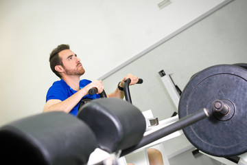 man practicing exercise in the gym