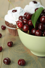 Chocolate Cupcakes with cherries on wooden background