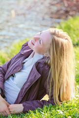 Naklejka premium Beautiful Woman Laying on River Bank