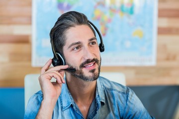 Smiling travel agent having phone call