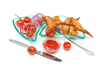 smoked wings, cherry tomatoes and onion in a glass dish on a whi