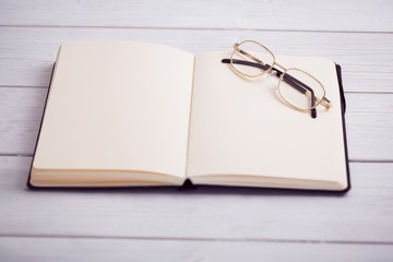 Fototapeta premium Empty notepad with reading glasses