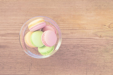 Different colors and  flavors French Macarons on  old wooden bac
