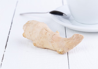 Fresh ginger and cup of green tea.