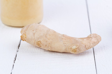 Fresh ginger with honey and cup of tea.