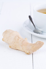 Fresh ginger and cup of green tea.
