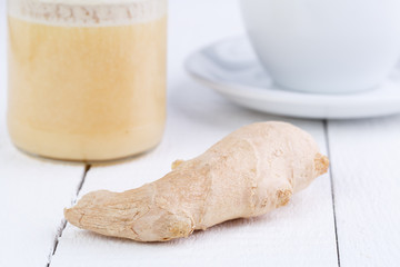 Fresh ginger with honey and cup of tea.