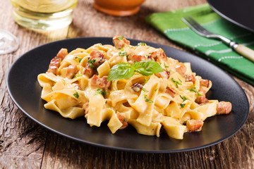 Pasta Carbonara with bacon, basil and cheese