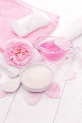 Fototapeta na wymiar sea salt and essential oils, pink tea rose flower. spa