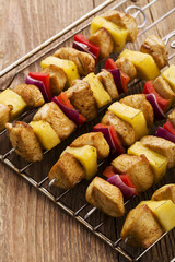 Grilled chicken skewers with pineapple, peppers and onions