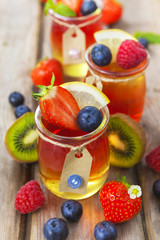 Red and yellow jelly served with fruit