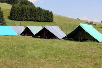 Fototapeta na wymiar tents of a campsite of the boy scouts in the mountains