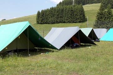 tents of a campsite of the boy scouts in the mountains in summer