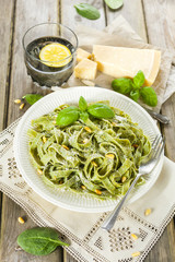 Homemade spinach pasta with pesto and Parmesan cheese