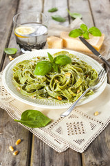 Homemade spinach pasta with pesto and Parmesan cheese
