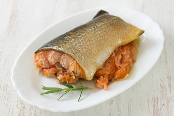 smoked salmon on dish on white wooden background
