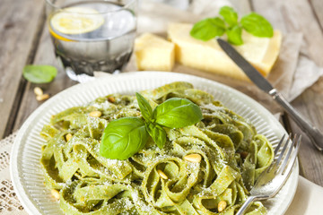 Homemade spinach pasta with pesto and Parmesan cheese