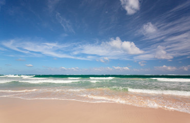 Blue sky and sea waves on the sand