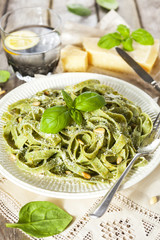 Homemade spinach pasta with pesto and Parmesan cheese