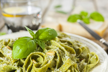 Homemade spinach pasta with pesto and Parmesan cheese