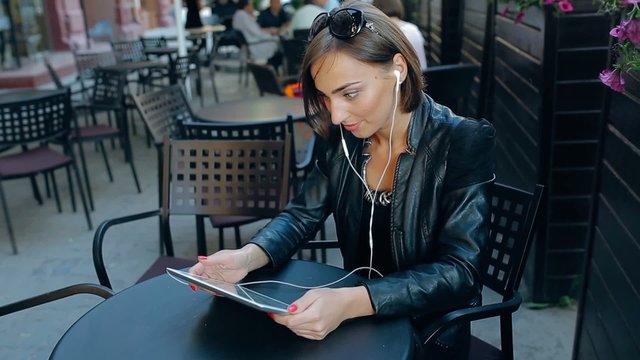 beautiful young woman uses phone and tablet