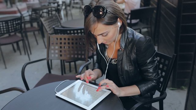beautiful young woman uses phone and tablet
