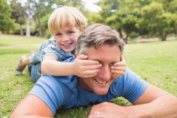 Happy father and his son smiling at camera