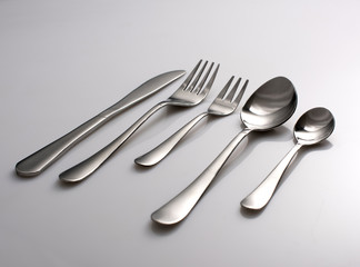 Silverware or flatware set of fork, spoons and knife