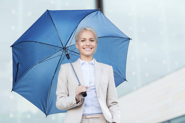 young smiling businesswoman with umbrella outdoors