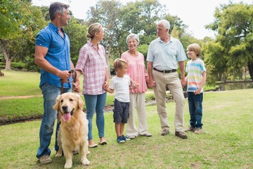 Happy family in the park with their dog