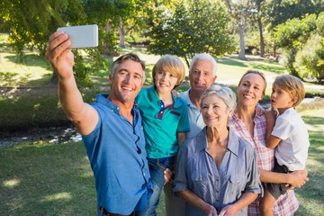 Happy family taking a selfie in the park