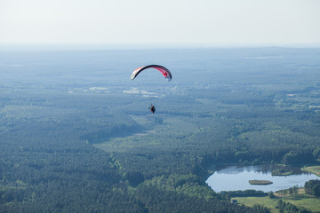 The motorized para glider in the blue sky