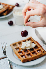 Breakfast with wholegrain waffles and whipped cream