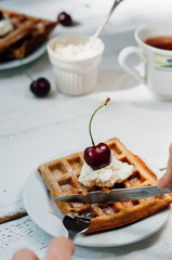 Breakfast with wholegrain waffles and whipped cream