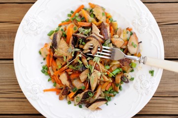 Porcini mushrooms ragout with carrot, scallion and thyme in whit