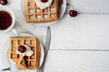 Breakfast with wholegrain waffles and whipped cream