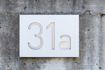 house number four on a concrete texture