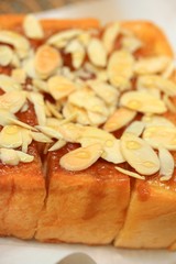 Toast bread topped with honey and almond.
