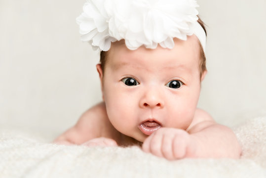 Portrait of newborn baby girl  with white headband