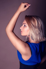 Obraz premium portrait of beautiful curly young blond woman posing in studio